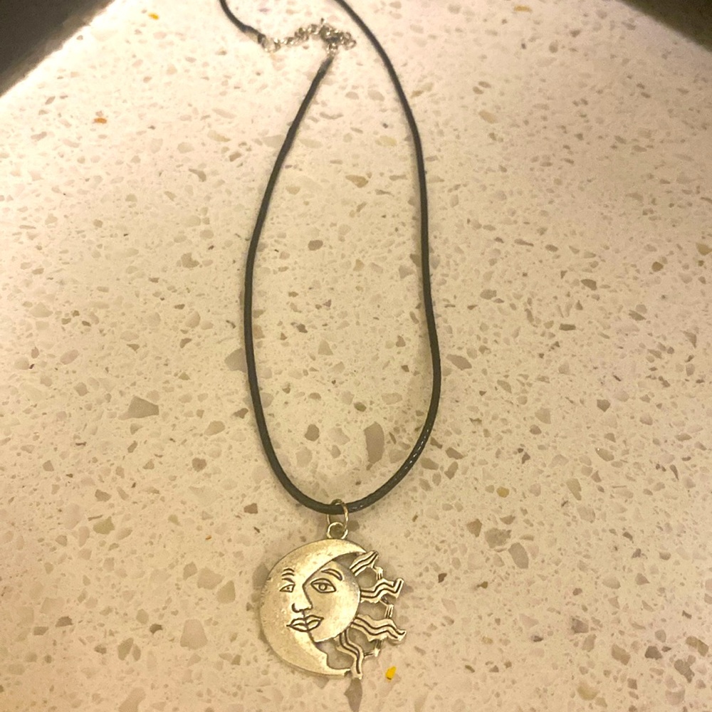 Sun and moon charm on a 16 inch  vinyl strap adjustable necklace